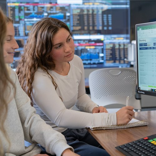 Two Students Collaborate Reviewing Financial Data Dsc07523
