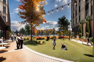 People are walking, sitting, and standing in a landscaped outdoor area between two buildings under string lights.