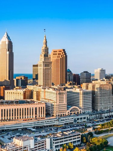 A skyline shows several tall buildings, clustered together near the river.