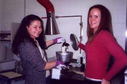 Two girls making a rat experiment