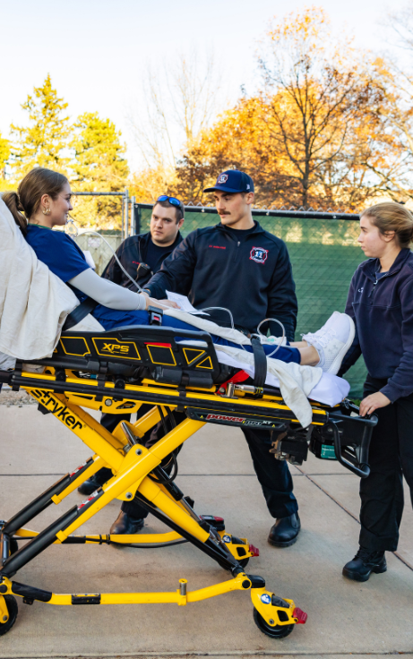 student on stretcher for EMS drill