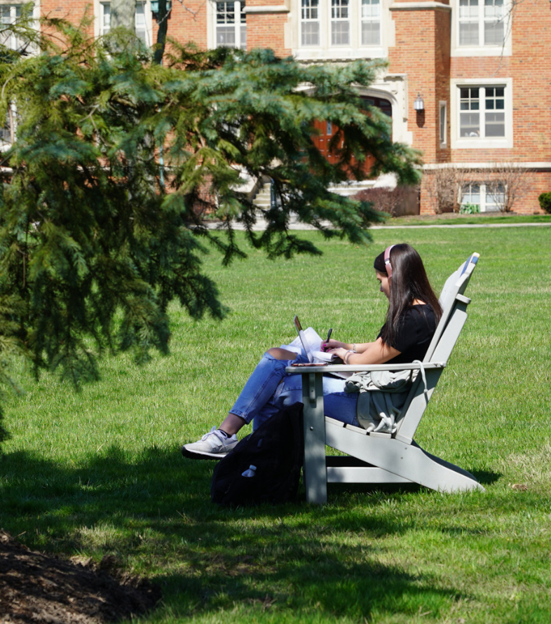 girl sitting in chair on quad