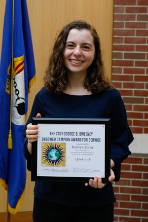 Kathryn Zoller '23 holding the Campion Award Certificate
