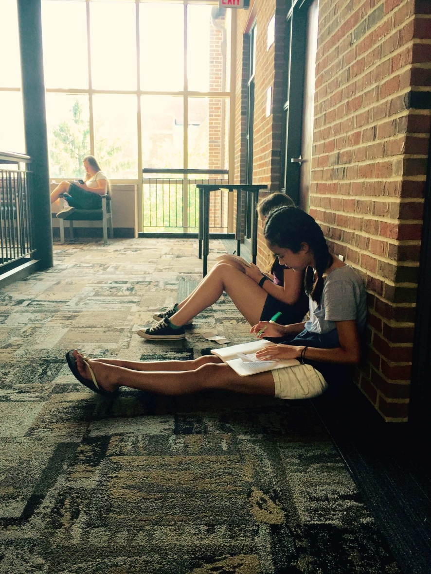 students reading in a hallway