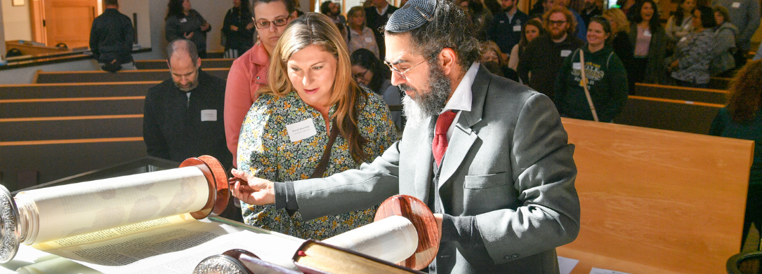 Rabbi Noah Bickart displaying Torah Scroll