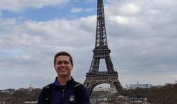 JCU student stands in front of the Eiffel Tower in Paris.