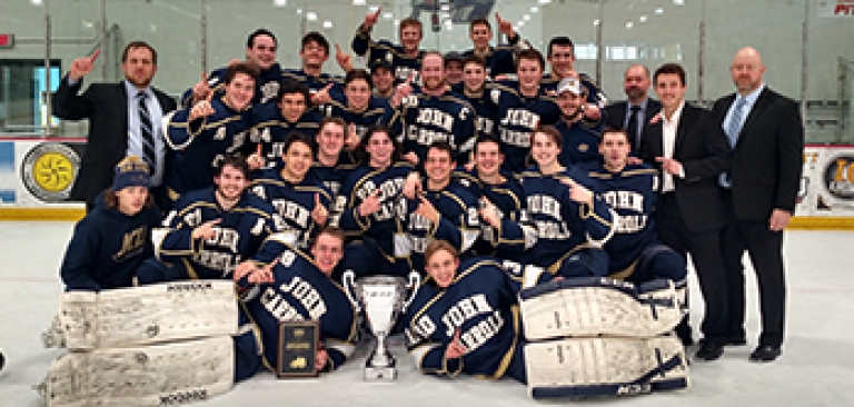 Team picture with trophy after the men's club hockey team won a championship 