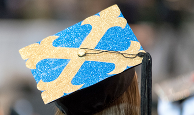 girl wearing graduation cap with JCU botany cross, viewed from back 